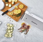 VS1500-foodsaver-white-ss-with-food-group-overhead-in-use-lifestyle-2